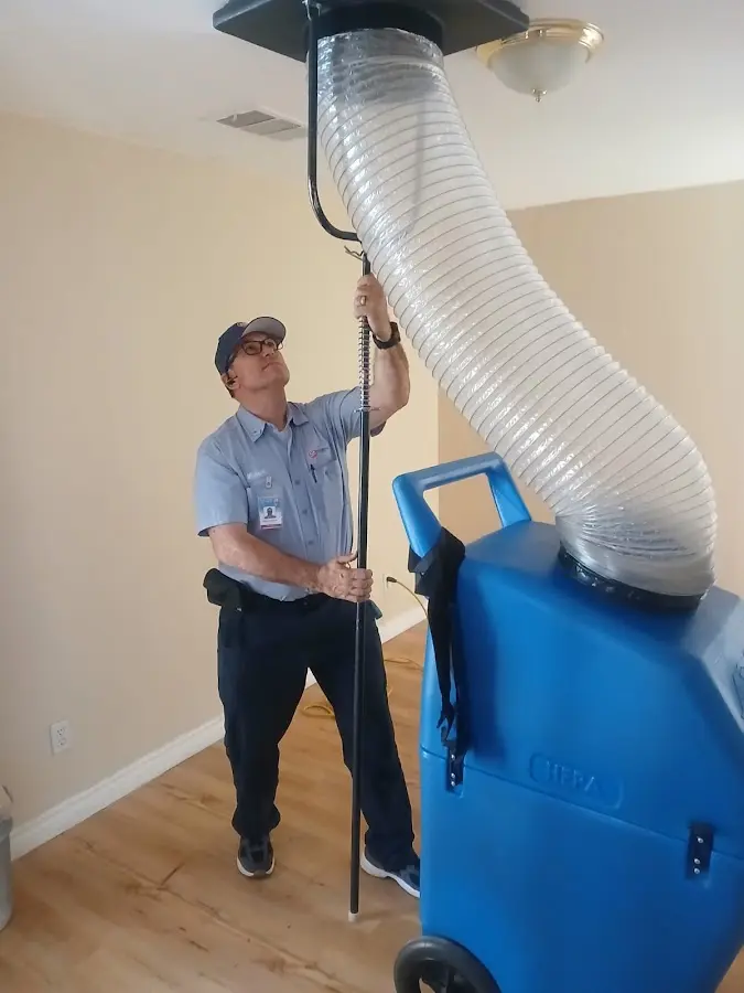 Furnace Tune-Up technician using HEPA equipment in Camino Tassajara