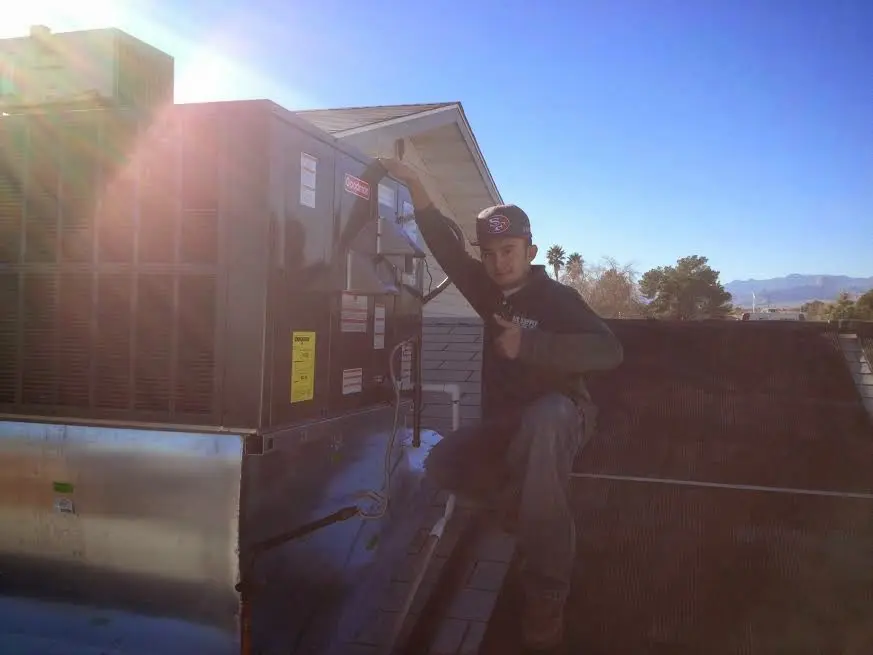 HVAC technician performing HVAC Inspection on a rooftop unit in Camino Tassajara